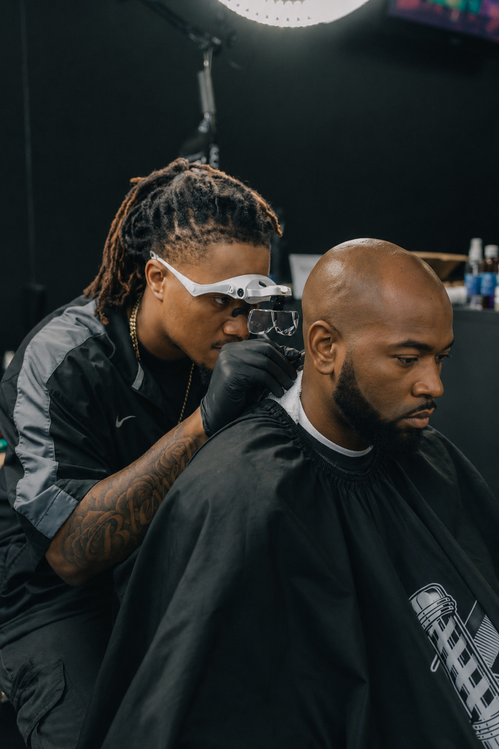 Barber using a magnifying loupe to closely examine a client's scalp and neckline